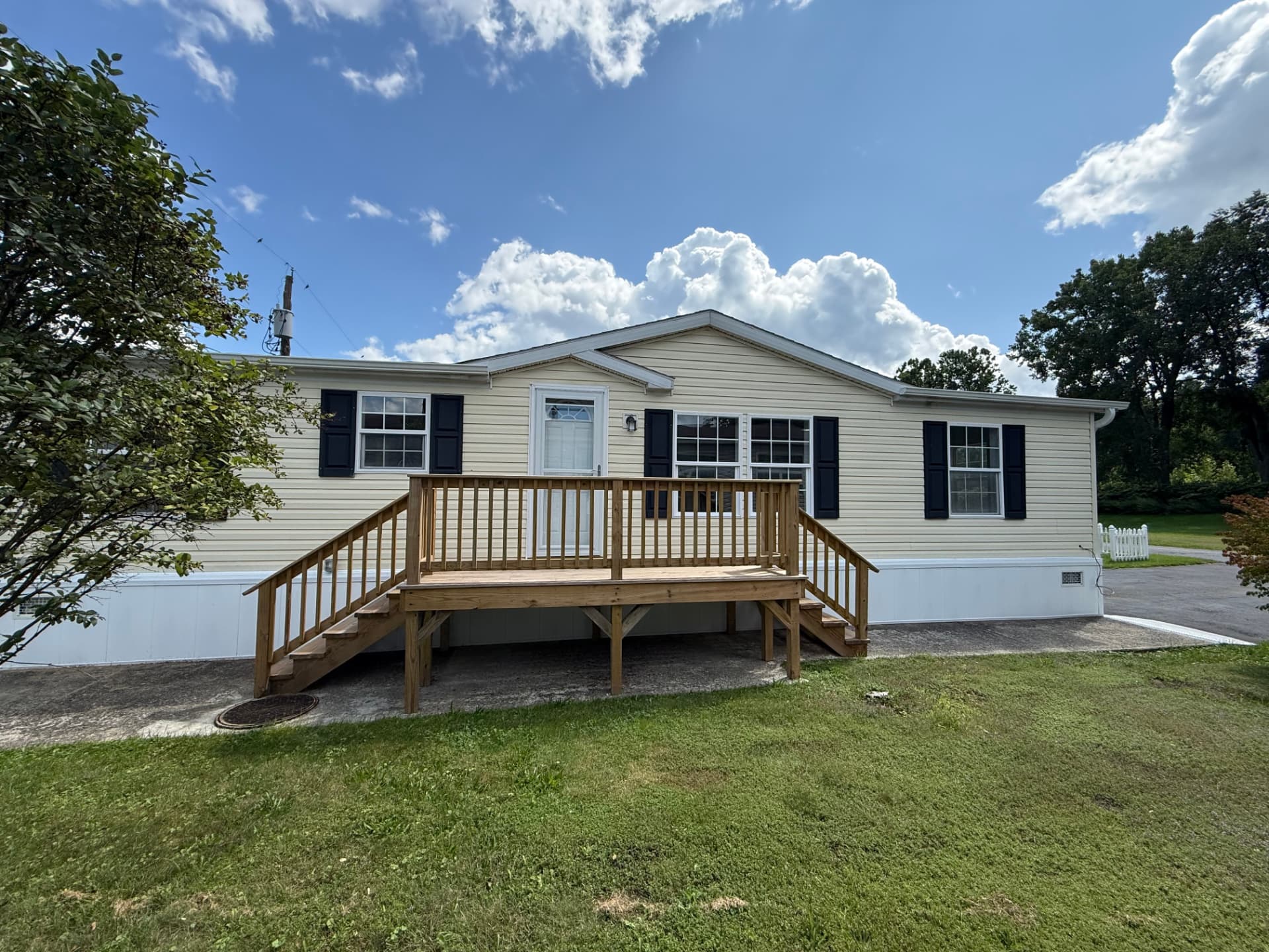 40 Michael — a light blue single-story home with a covered entry and paved drive