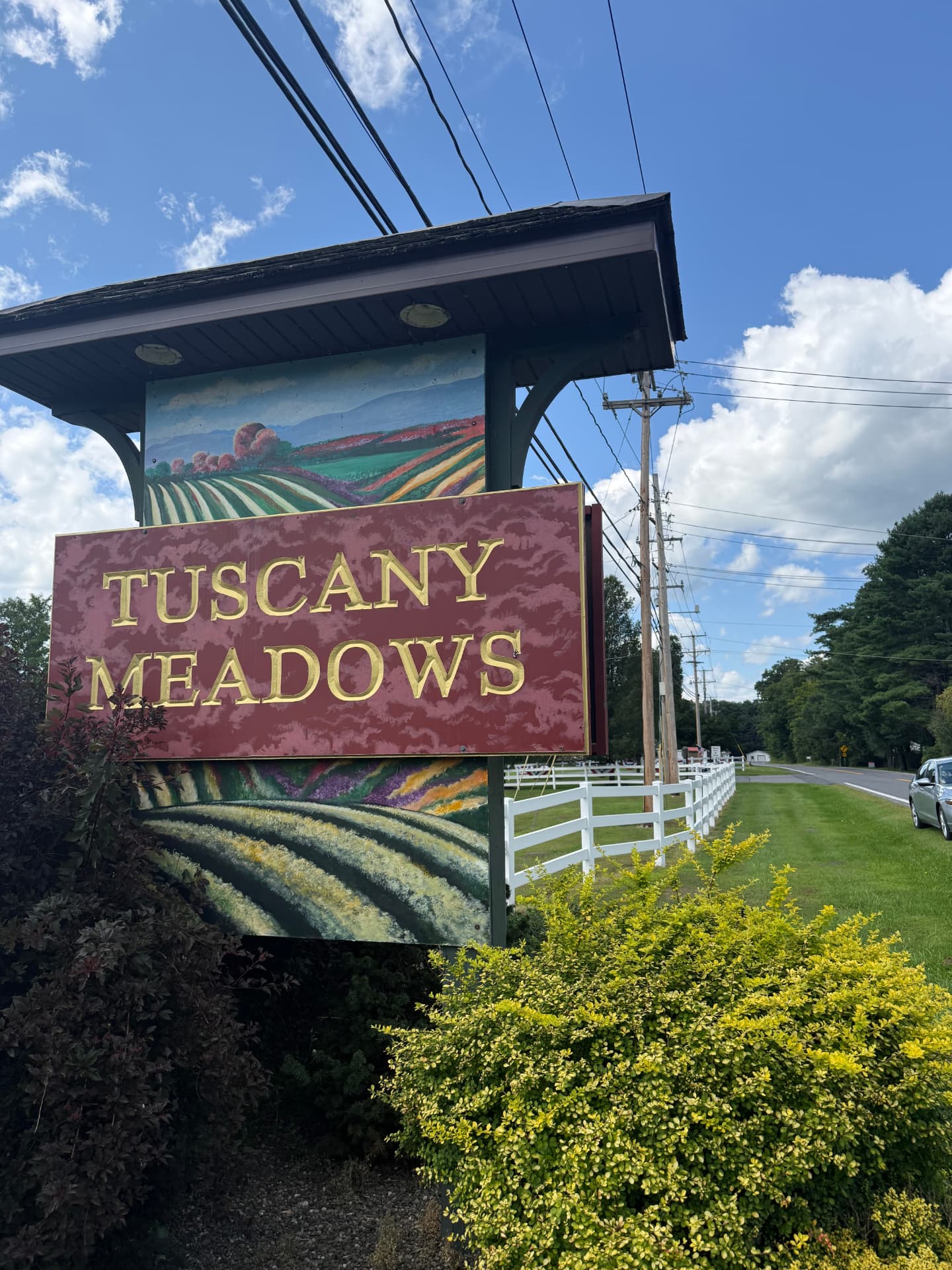 The landscaped entrance sign at Tuscany Meadows